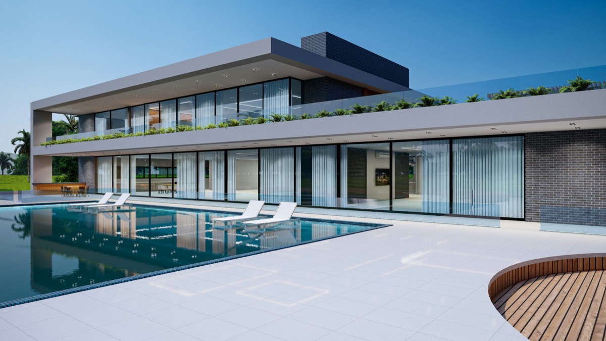 A modern villa with a swimming pool at the rear.